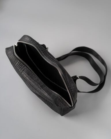 Leather belt bag (banana) in black, crocodile embossed