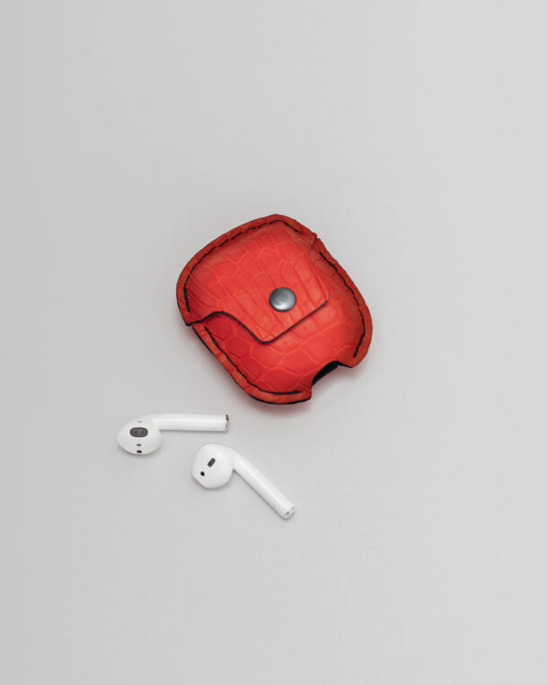 Case for AirPods made of red skin of a crocodile