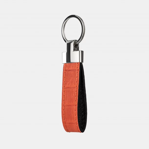 Keychain made of red embossing under a crocodile